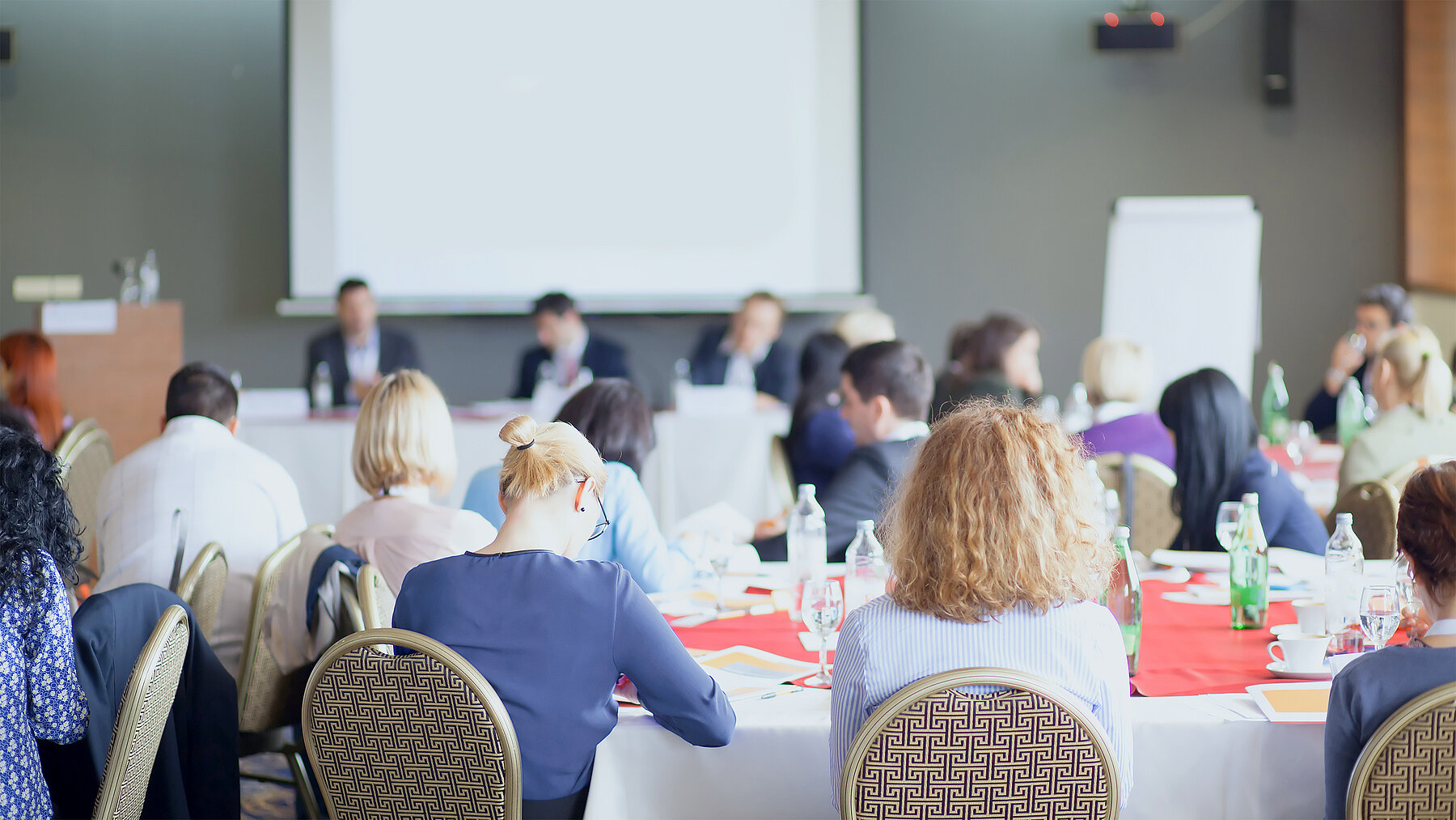 Ein Workshop mit Menschen an mehreren Tischen